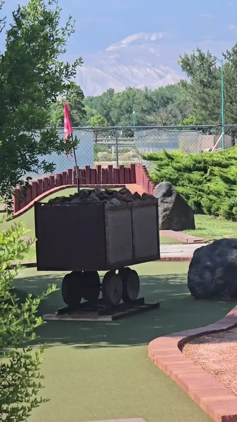 Mine cart obstacle with the Colorado mesa behind it